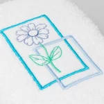 TOALLA DE ROSTRO BORDADA FLOR MARCO CELESTE
